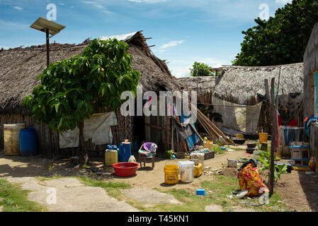 Traditional Kuna housing (rural thatch houses) in Carti Island, Guna Yala indigenous village & solar panel on roof. San Blas Islands, Panama. Oct 2018 Stock Photo