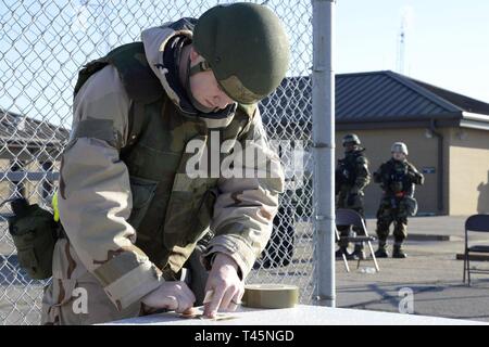 SSgt. Charles Munson, 436th Civil Engineer Squadron Readiness and Emergency Management Flight journeyman, places M8 chemical agent detector paper on a zone transition point during Exercise Jersey Devil 19 at the Mississippi Air National Guard’s Combat Readiness Training Center in Gulfport, Miss. Mar. 5, 2019. Jersey Devil 19 is a contingency full spectrum readiness exercise to train mobility Airmen to survive in a contested environments. Stock Photo