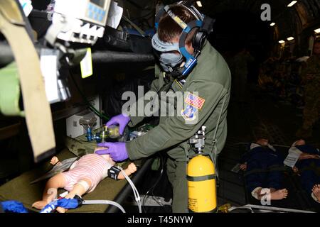 U.S. Air Force 1st Lt. Hunter Heggerston, a flight nurse with the 109th Aeromedical Evacuation Squadron, Minnesota Air National Guard, gives rescue breaths during simulated aeromedical evacuation training on a C-17 Globemaster III, as a part of the PATRIOT South 19 exercise March 5, 2019, at the Savannah Air National Guard Base, Georgia. PATRIOT South 19 is a domestic operations disaster-response training exercise conducted by National Guard units working with federal, state and local emergency management agencies and first responders. (Air National Guard Stock Photo