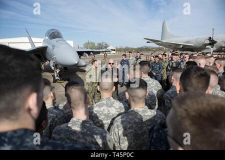 COLLEGE STATION, Texas (March 5, 2019) -- Capt. Steven Hnatt, a naval flight officer assigned to the Chief of Naval Air Training in Corpus Christi, Texas, addresses nearly 200 Texas A&M Navy ROTC students during a static display event at Easterwood Airport in College Station, March 5. The event provided an opportunity for college students to speak with pilots about a potential career within Naval Aviation. Stock Photo