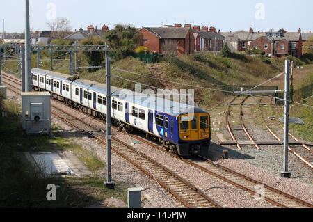Class 319 Northern electric multiple unit train operated by Northern arriving Poulton-le-Fylde station with express passenger service 13th April 2019. Stock Photo