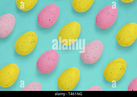 Pink and yellow Easter eggs on a bright blue background Stock Photo