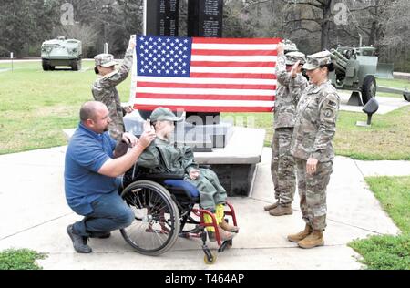 Drake Quibodeaux, 8, a youngster from Vinton, La., takes the oath of enlistment from Lt. Col. Sonja Whitehead, commander, 519th Military Police Battalion, at Warrior Memorial Park March 1. Quibodeaux, who suffers from a brain tumor, and his family were invited to Fort Polk where Drake was made an honorary Soldier. Stock Photo