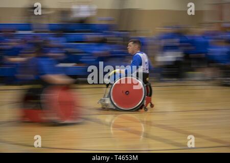 Tech Sgt. Trevor Brewer is flying across the court during the wheelchair rugby competition at the 2019 Air Force Trials at Nellis AFB, Nev. This is the second year Trevor has competed here and he's really pushing hard for personal bests in every sport. Air Force Trials is a Paralympic-style competitive event featuring eleven adaptive sports. It has a two-fold purpose, one is to select the 40-person primary and 10-person alternate members for Team Air Force. The second is to highlight the effectiveness of adaptive sports in aiding wounded warriors in their recovery and long-term resiliency. Stock Photo