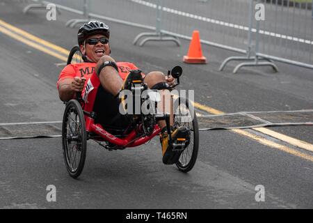 U.S. Marine Corps Staff Sgt. Jose Panez crosses the finish line in the 2019 Marine Corps Trials cycling competition at Marine Corps Base Camp Pendleton, California, March 3. The Marine Corps Trials promotes recovery and rehabilitation through adaptive sports participation and develops camaraderie among recovering service members and veterans. (Official U.S. Marine Corps Stock Photo