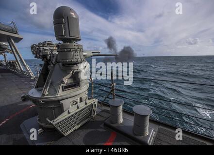 OCEAN (March 11, 2019) – A Mark 38 25mm machine gun fires aboard the Arleigh Burke-class guided-missile destroyer USS Porter (DDG 78) during a live-fire exercise in the Atlantic Ocean, March 11, 2019. Porter, forward-deployed to Rota, Spain, is on its sixth patrol in the U.S. 6th Fleet area of operations in support of U.S. national security interests in Europe and Africa. Stock Photo