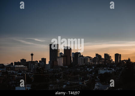 Calgary skyline in the late afternoon with rays from setting sun reflecting off glass buildings. Stock Photo
