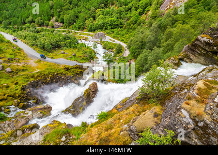 Scenery Waterfall In Briksdal Glacier In Norway. Beautiful waterfall from the meltwater of the Brixdal Glacier in Norway, bottom view. Panoramic view  Stock Photo