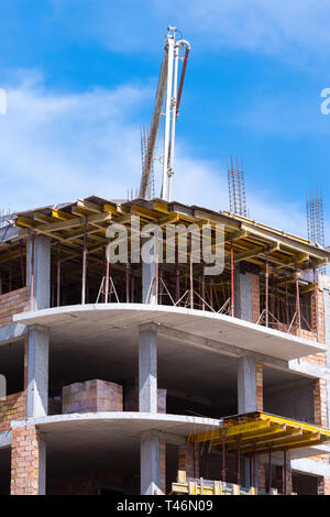 Automobile concrete pump. Construction site. New multi-storey building. Stock Photo