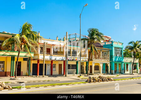 Old Spanish colonial houses with palms along the street in the center of Cienfuegos, Cuba Stock Photo