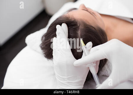 treatment of hair loss, injection for hair growth. Injected in woman's head, hair mesotherapy Stock Photo