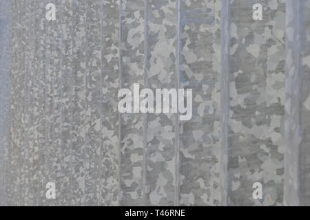 Old gray metal fence with a spotted pattern. Selective focus Stock Photo