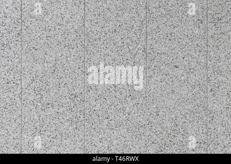 Wall of the building of granite material with seams Stock Photo