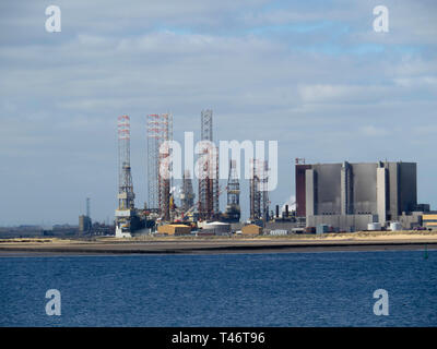 Jack Up drilling rigs at the TERRC Hartlepool  facility on the river Tees for storage  and repair by Hartlepool Nuclear Power Station Stock Photo