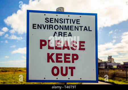 A warning sign for a Sensitive Environmental Area Please Keep Out   erected outside the now disused steel making blast furnace plant in Redcar Stock Photo