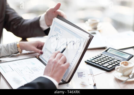 close up. colleagues discuss financial schedule Stock Photo