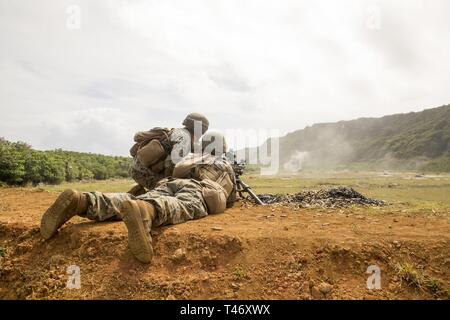 Lance Cpl. Aaron Luna, a mortarman with Battalion Landing Team, 1st Battalion, 4th Marines, the “China Marines,” fires an M240G medium machine gun during live-fire training at Anderson Air Force Base, Guam, March 12, 2019.  Luna, a native of Los Angeles, graduated from Ouchi High School in June 2017 before enlisting in the same month. Alpha Company Marines are the small boat raid specialists for BLT 1/4, the Ground Combat Element for the 31st Marine Expeditionary Unit. The 31st MEU, the Marine Corps’ only continuously forward-deployed MEU partnering with the U.S. Navy's Amphibious Squadron 11, Stock Photo