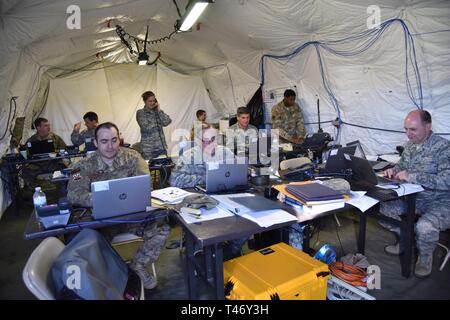 Members of the 226th Combat Communications Group with the Alabama National Guard, work in the Air Communications Control Center during the Combat Communications Rodeo, hosted by the 5th Combat Communications Group at Robins Air Force Base, Georgia, March 12, 2019. The rodeo is an event where combat communications units train and execute various skills such as installation and sustainment of tactical communications systems, tent set-ups, team tactics, camouflaging equipment, and other skills needed to be mission ready. Stock Photo