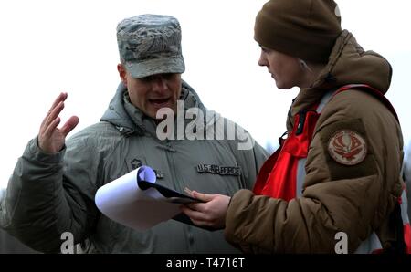 U.S. Air Force Senior Master Sgt. Jeremy Wohlford (left) with Alpena Combat Readiness Training Center, Michigan, explains the importance of following proper rescue procedures to a Latvian soldier (right) during a mass casualty training for exercise Ready To Fight, March 14, at Lielvarde Air Base, Latvia. Ready To Fight is a multinational exercise which demonstrates the collective defense achieved as the U.S. skillfully works together with ally and partner nations. Participation in multinational exercises like RTF develops professional relationships and improves overall coordination with allies Stock Photo