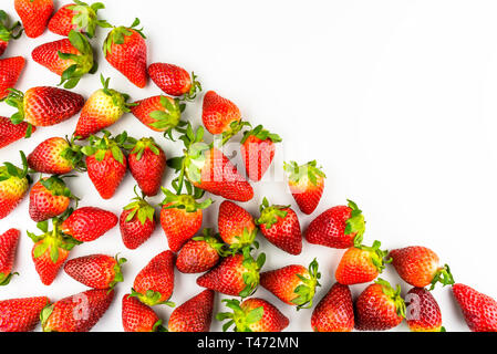 Pattern made from fresh strawberries, top view, flat lay pattern, isolated on a white background with space for text on the upper right side. Stock Photo