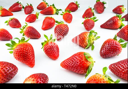 Pattern made from fresh strawberries, view from the skew, isolated on a white background. Stock Photo