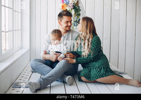Family at home sitting on the floor Stock Photo