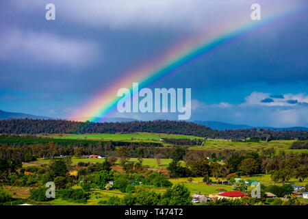 Rainbow over our little township in Tasmania Stock Photo