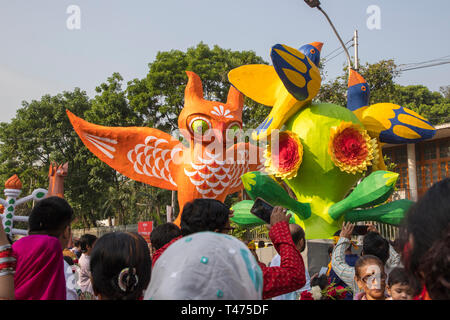 Dhaka, Bangladesh. 14th Apr, 2019. Mangal Shobhajatra, a colourful and festive procession celebrating Pahela Baishakh, the Bangala New Year, sets off  Stock Photo