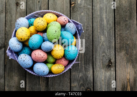 Closeup of colorful easter eggs collected in a bucket, season holiday concept - Image Stock Photo