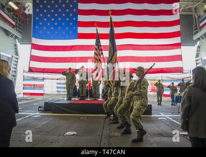 DIEGO (March 15, 2019) — The color guard parades the colors during a change of command ceremony held in the well deck of the amphibious assault ship USS Makin Island (LHD 8). During the ceremony, Capt. Christopher Westphal relieved Capt. David Oden as the commanding officer.  Makin Island, homeported in San Diego, is conducting a depot-level maintenance availability. Stock Photo