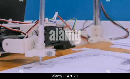 Robotic arm with black pen drawing portrait Stock Photo