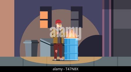 poor bearded man warming his hands by fire beggar guy standing near burning garbage in barrel homeless jobless concept trash can city night street Stock Vector