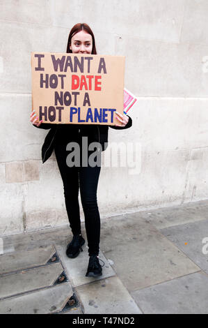 London, Trafalgar Square. April 12th 2019. Youth strike for climate change. A young woman holds a placard saying 'I want a hot date not a hot planet'. Stock Photo