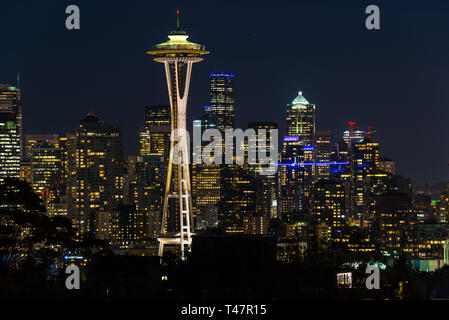 Night view of the Seattle skyline with the Space Needle and other iconic buildings in the background.