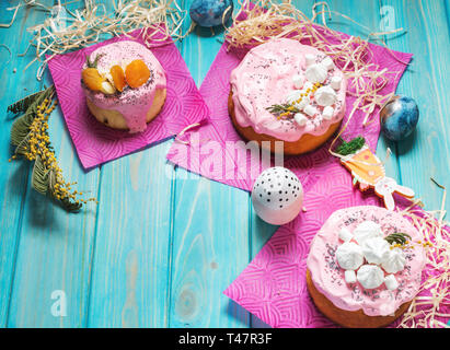 Easter composition with orthodox sweet bread, kulich and eggs on blue wood background. Stock Photo
