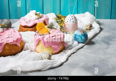 Easter composition with orthodox sweet bread, kulich and eggs on concrete background. Stock Photo