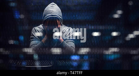 Hacker in hoodie dark theme Stock Photo