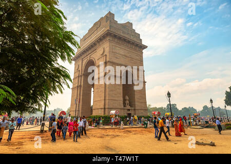 Tourists flock at India Gate New Delhi war memorial on Rajpath road at sunset with moody sky Stock Photo