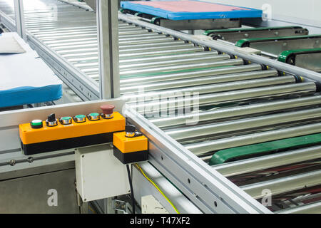 The emergency stop button on conveyor chain, and conveyor belt or auto machine  in production line area. Stock Photo