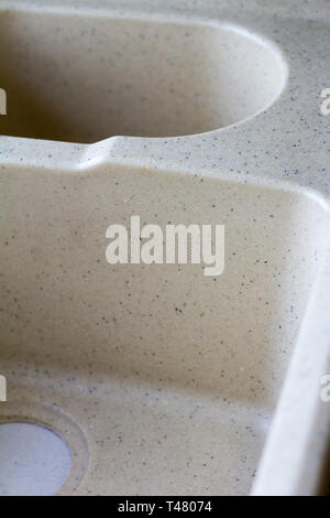 Kitchen sink from a light artificial stone on two bowls in a warehouse before installation in modern kitchen. Stock Photo