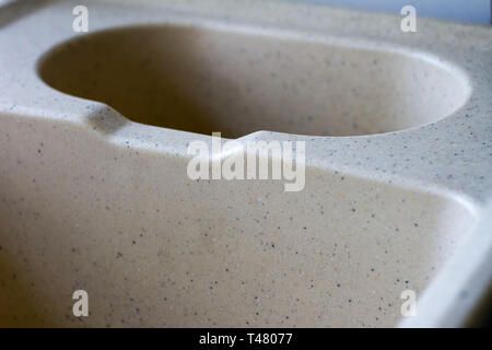 Kitchen sink from a light artificial stone on two bowls in a warehouse before installation in modern kitchen. Stock Photo