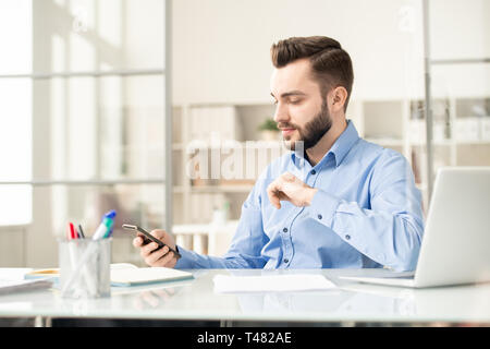 Manager with smartphone Stock Photo