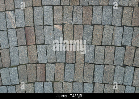 Top view on stone road close up. Pavement of granite. Brown square cobblestone sidewalk. Mock up or vintage grunge texture. Stock Photo