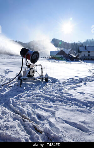 Ski slope with artificial snow machine Stock Photo - Alamy