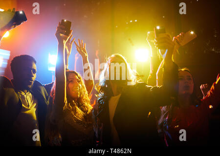 Jolly people screaming at musical concert Stock Photo