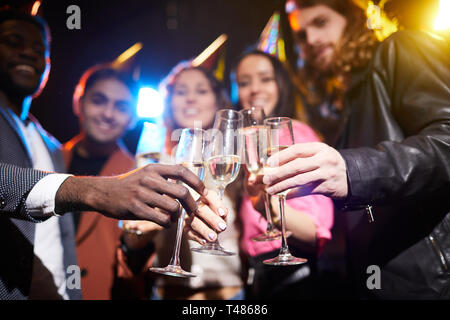 Full champagne flutes in hands of friends Stock Photo