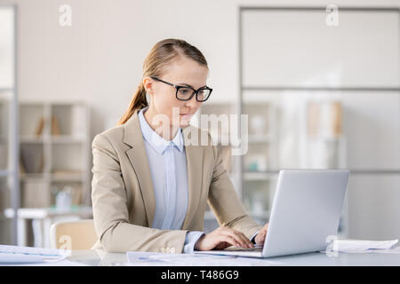 Busy woman preparing presentation on laptop Stock Photo