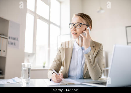 Inspired business lady talking on phone Stock Photo