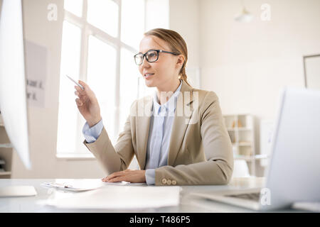 Lady analyzing sales data on computer Stock Photo