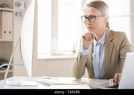 Concentrated lady analyzing documents Stock Photo